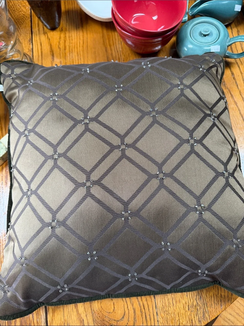 Reba green velour pillow with embroidered scroll design on front.